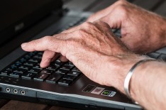 Hands typing at a keyboard