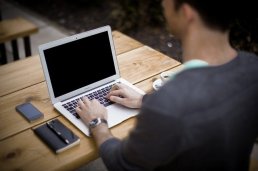 Young man typing on a laptop