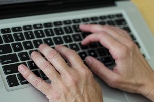 Hands typing on a keyboard